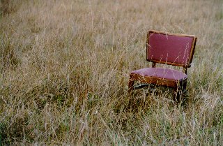 lone chair standing in a field